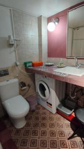 a bathroom with a toilet and a sink and a washing machine at Polytropon Studio ground floor in Kefallonia +62 photos