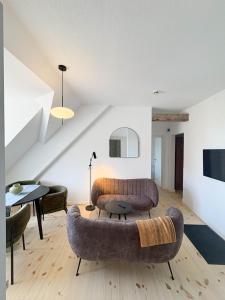 a living room with a couch and a table at Apartments am Alten Markt in Stralsund