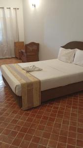a large bed in a room with at Paradiso Hotel in Dar es Salaam