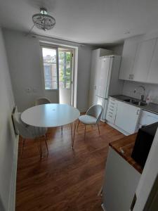 a kitchen with a table and chairs in a room at Old appartment in Helsingborg