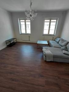 a living room with a couch and a chandelier at Old appartment in Helsingborg