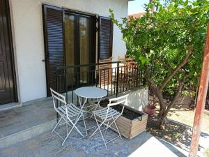 a table and chairs sitting on a porch at Sea view Dilesi in Dhílesi