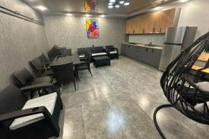 a waiting room with tables and chairs and a kitchen at Millenium Villa in Kʼanakʼerravan +5 photos