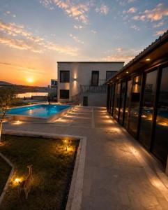 a house with a pool and a dog standing in the yard at Millenium Villa in Kʼanakʼerravan