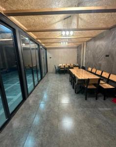 a conference room with tables and chairs and windows at Millenium Villa in Kʼanakʼerravan