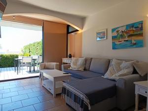 a living room with a couch and a table at La Croix Valmer in La Croix-Valmer