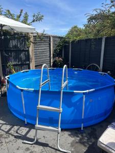 a blue hot tub with a ladder around it at Studio Apartment in Ferndown