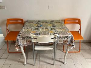 a table with two chairs and a table cloth on it at Corte Del Borgo Antico in Bari