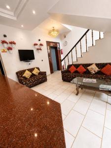 a living room with couches and a flat screen tv at Hotel Swisston Palace in New Delhi