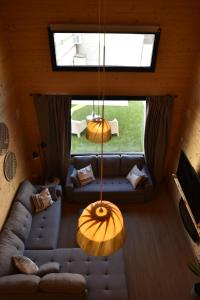 a living room with two couches and a large window at Casa rural El Pinton in Gálvez