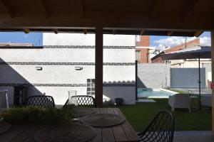 a patio with a table and chairs and a pool at Casa rural El Pinton in Gálvez
