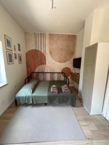 a small bedroom with a bed and a rug at Il Piccolo Aranceto in Motta SantʼAnastasia