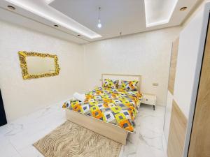 a bedroom with a bed and a mirror on the wall at Manifique renovated apartment Marrakech in Marrakesh +1 photo