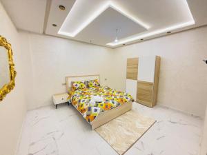 a bedroom with a bed in a white room at Manifique renovated apartment Marrakech in Marrakesh