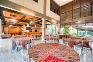 a dining room with a large table and chairs at Rivora Gopeng in Gopeng