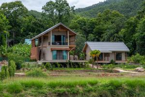 a house in the middle of a field at The BROWN PAI in Pai
