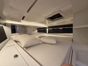 ein großes weißes Bett in einem Boot mit Kissen in der Unterkunft Diva Catamarano in Feriolo