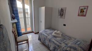 a bedroom with a bed and a chair and a window at Sirena Vista Lago in Stresa +69 photos
