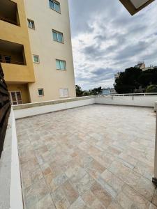 a large patio in front of a building at Stylish Apartment with Spacious Terrace in Aglantzia
