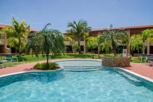 a swimming pool in front of a resort at Family-Flexication-Friendly Villa, few steps from Eagle Beach in Palm-Eagle Beach