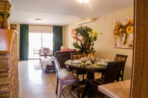 a dining room and living room with a table and chairs at Family-Flexication-Friendly Villa, few steps from Eagle Beach in Palm-Eagle Beach