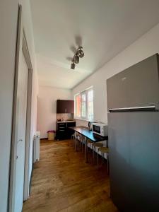 a kitchen with a table and chairs in a room at Calypso Rooms in Făgăraş