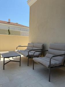 three chairs and a table in a room at Charming studio-plus in Lustica Bay Centrale in Radovici