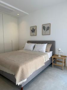 a bedroom with a large bed and a side table at Charming studio-plus in Lustica Bay Centrale in Radovici