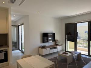a living room with a couch and a tv at Charming studio-plus in Lustica Bay Centrale in Radovici