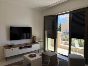 a living room with a tv and a large window at Charming studio-plus in Lustica Bay Centrale in Radovici +7 photos