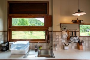 a kitchen counter with a sink and a window at The BROWN PAI in Pai +70 photos