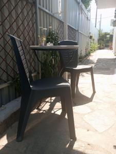 a table and a chair sitting next to a table at Basic in Kalamata +7 photos