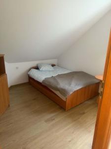 a bedroom with a bed in a attic at Hostel in Piotrków Trybunalski