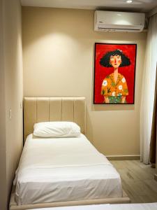 a bedroom with a bed with a painting on the wall at Lost At Sea 2 in Sarandë