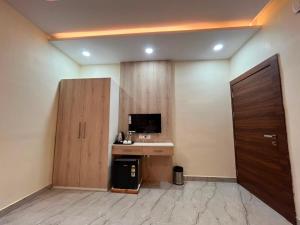 a room with a desk and a computer and a door at Hotel Shanvi Inn in Jabalpur +21 photos