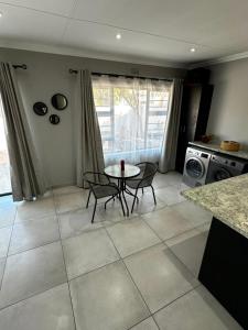 a kitchen with a table and chairs in a room at Klein Escape in Wilderness +15 photos