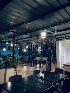 a room with a table and chairs and potted plants at Hotel Arawali Hill in Udaipur