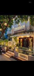 a hotel entrance with a sign in front of a building at Hotel Arawali Hill in Udaipur