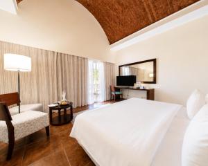 a bedroom with a white bed and a chair at Gemma Resort in Marsa Alam City +97 photos