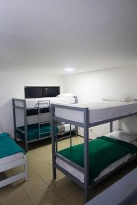 a room with three bunk beds and a counter at Hostel Way Fortaleza in Fortaleza