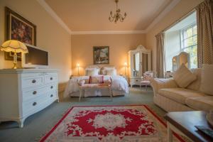 a living room filled with furniture and decor at Bankton House in Livingston