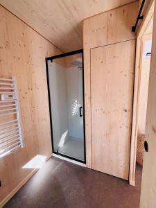 a room with a glass door in a house at Les Deux M Tiny House with Private Garden in Sorgues