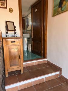 a bathroom with a toilet and a wooden door at Tuscany Location in Marta +52 photos
