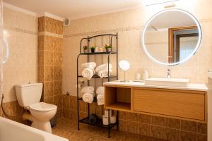 a bathroom with a sink toilet and a mirror at Theatre Home Aegean View in Nea Moudania +95 photos