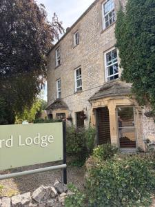 a sign in front of a large brick building at Burford Lodge - Adults only in Burford +24 photos