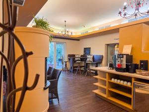 a living room with a kitchen and a dining room at Rosenhotel - Serviced Apartments in Zwentendorf