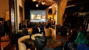 a group of people sitting in a room watching a presentation at MI CASA Luang Prabang in Luang Prabang