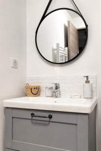 a bathroom with a sink and a mirror at Studio duplex à Savenay - Calme & tout confort entre Nantes & l'océan in Savenay
