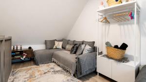 a living room with a couch and a table at Studio duplex à Savenay - Calme & tout confort entre Nantes & l'océan in Savenay