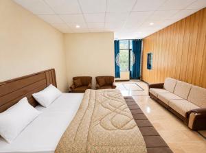 a hotel room with a bed and a couch at Kove Hotel & Resort in Naran